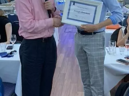Prof. Roger Jones of Manchester University presents Joe Bateman with the poster prize at the VHEE'2023 conference dinner