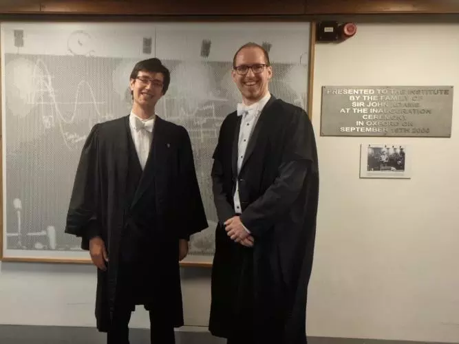 Seb Wilkes and Prof. Adrian Oeftiger standing, smiling in formalwear